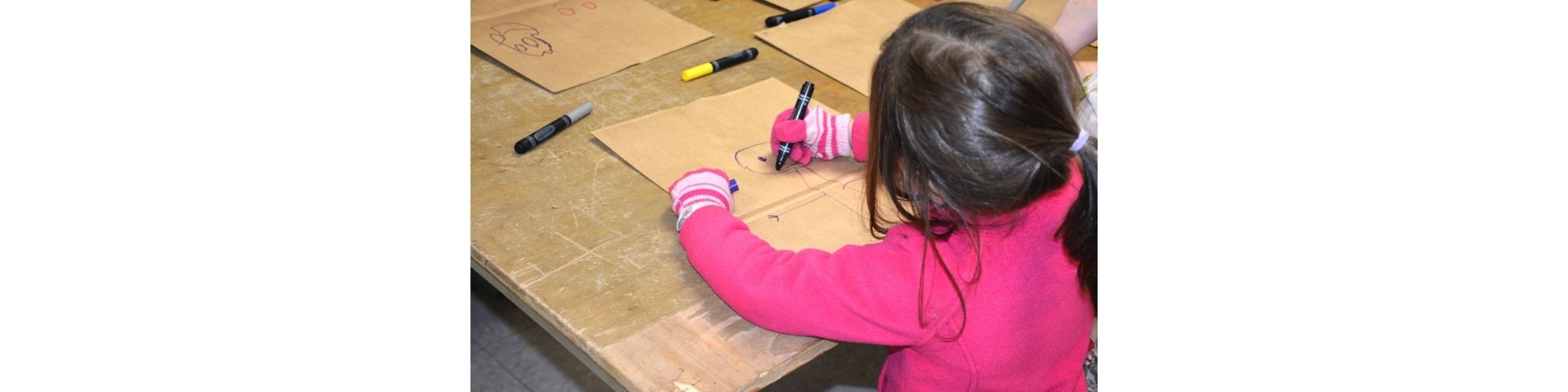 Child drawing on paper bags for SeniorPak